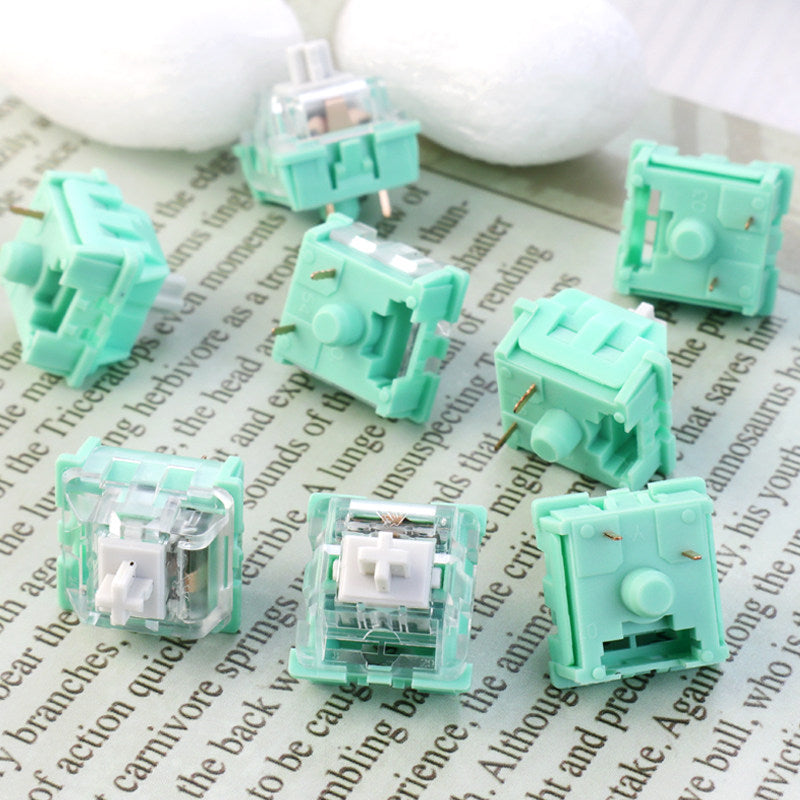 Green mechanical keyboard switches on a piece of paper