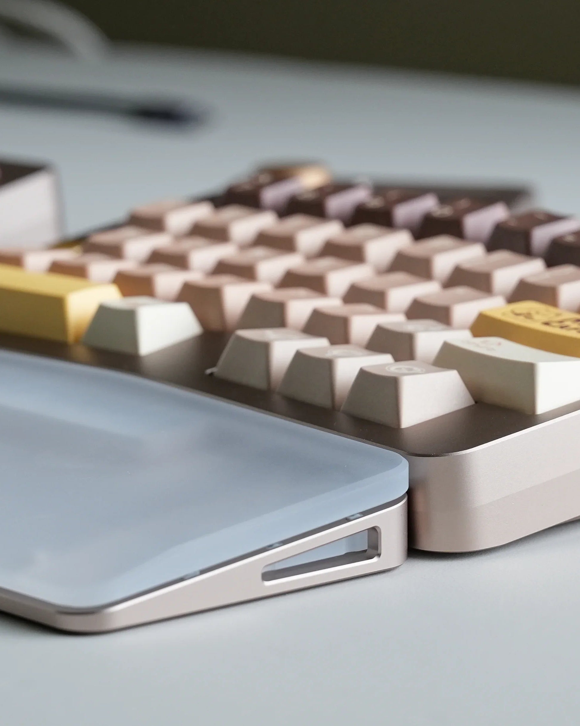 Close-up of a mechanical keyboard with a minimalist design on a light surface.