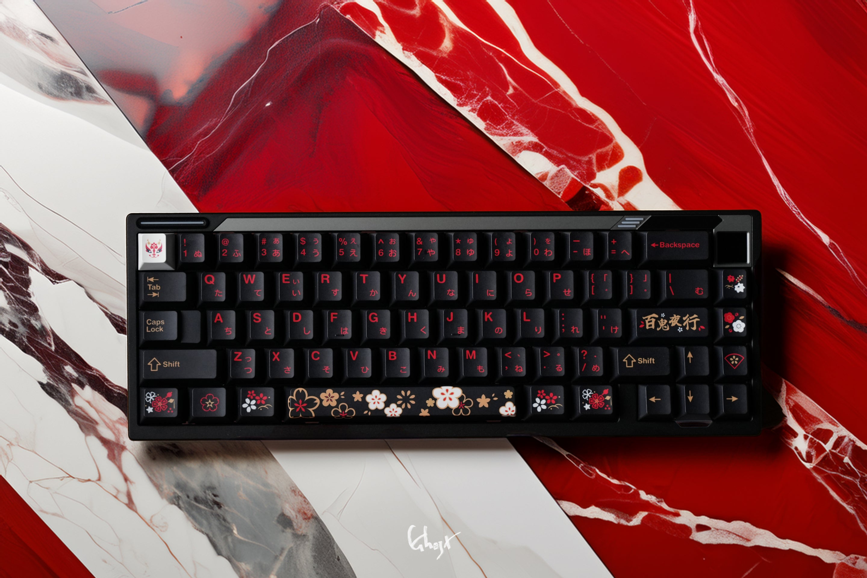 Black mechanical keyboard on a red and white marble surface