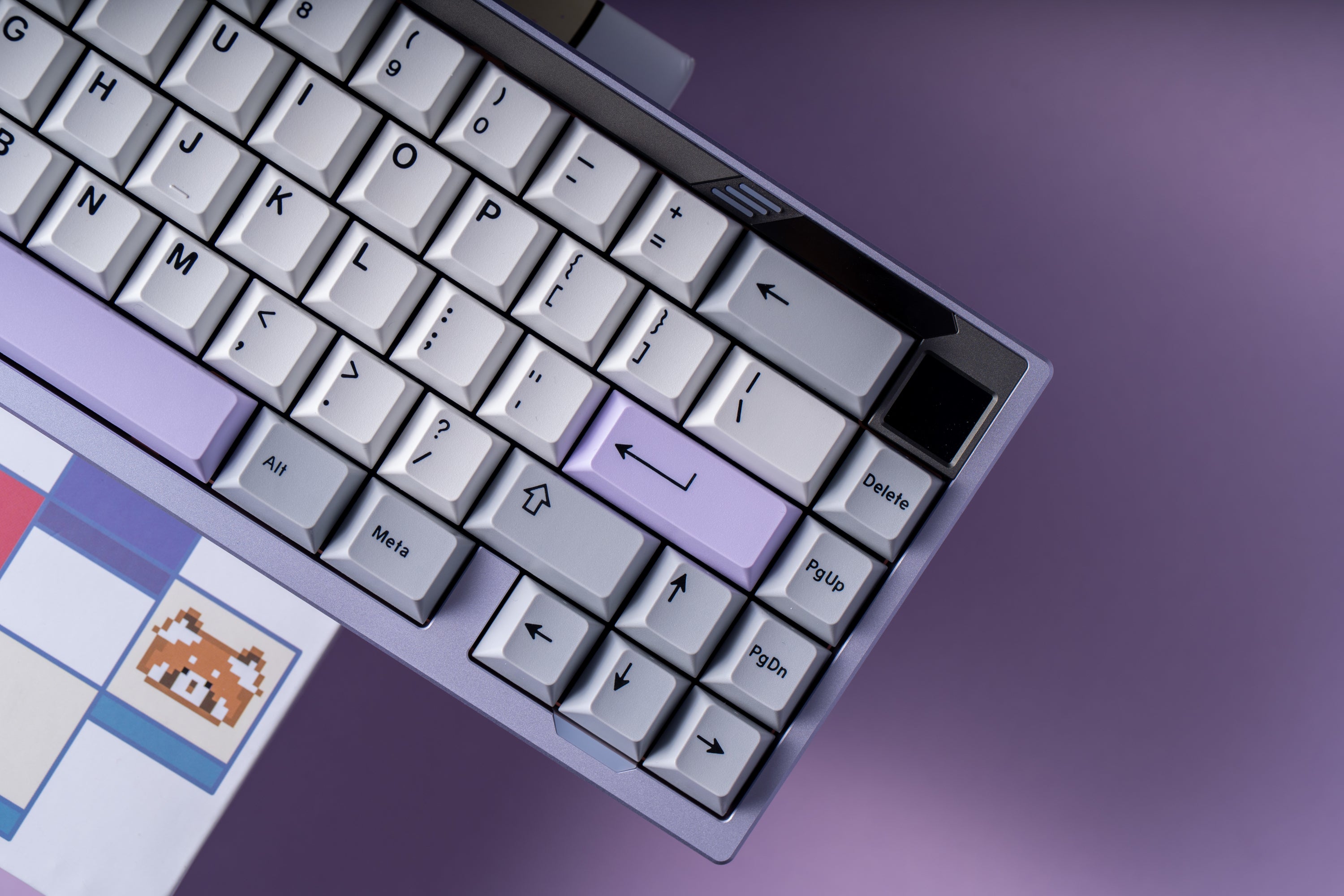 Close-up of a mechanical keyboard with a purple backlight on a purple background