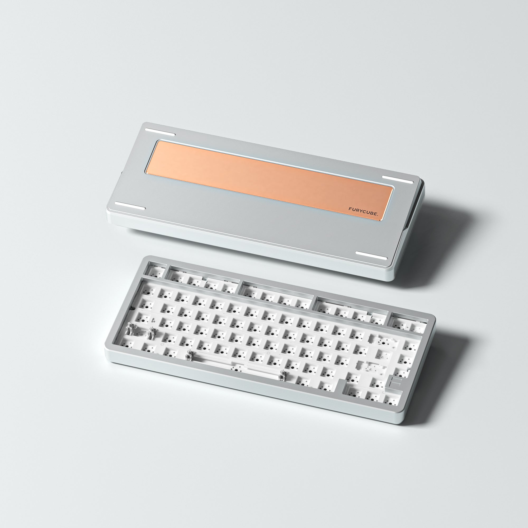 Barebone mechanical keyboard with a metallic cover on a light gray background