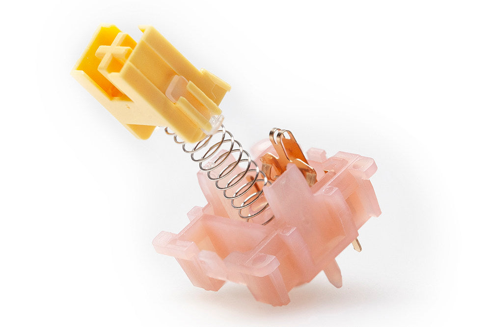 Mechanical component with yellow and pink parts on a white background