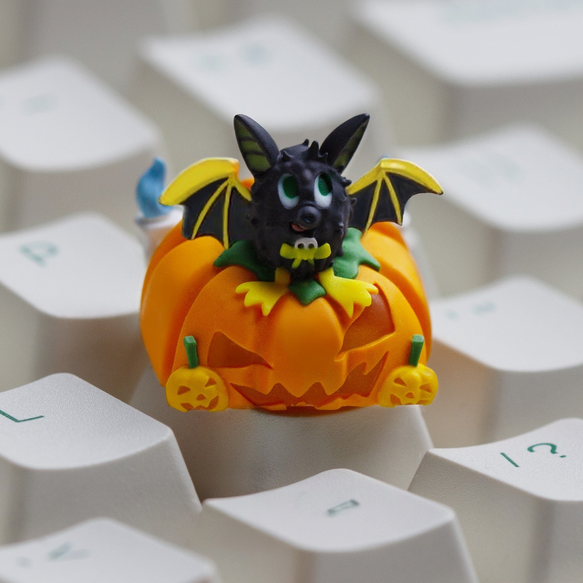 OZO Keyboards artisan keycap featuring a cute black bat sitting in a carved orange jack-o-lantern pumpkin