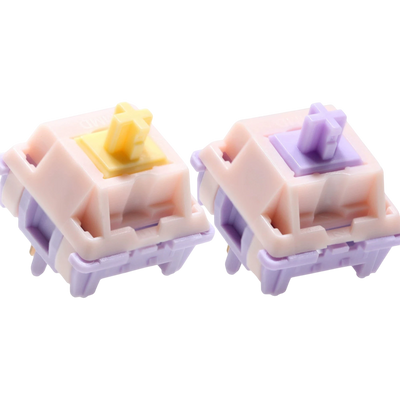 OZO Keyboards MMD Princess V2 mechanical switches with pink housings and yellow or purple stems on white background