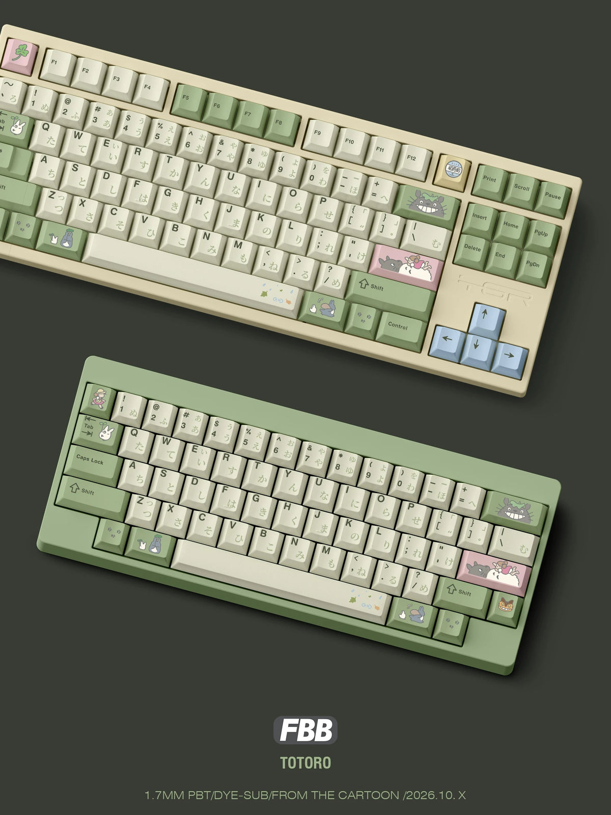 Totoro keycap set on cream TKL and green 60% keyboards, angled view