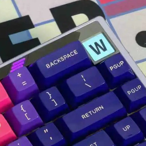 Close-up of a paper 65 mechanical keyboard showcasing 1u screen typing feedback, with W letter displayed on a screen.