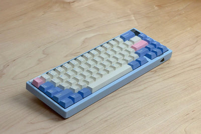 Paper65 mechanical keyboard in cloud blue case colour with pastel keycaps on a wooden surface